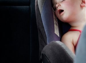 Baby asleep in a car seat